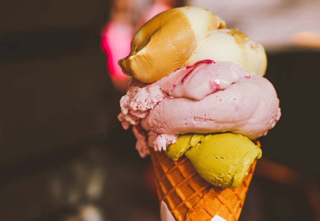 Ice cream cone melting outdoors in summer.