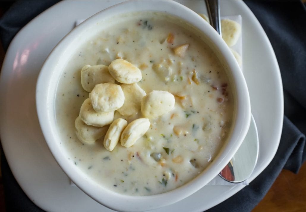 Creamy New England Clam Chowder garnished with oyster crackers