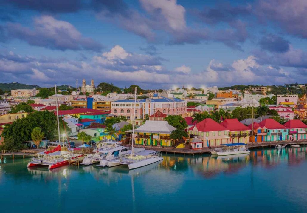 Colorful houses by the ocean in Saint John, the capital city of Antigua Barbuda.