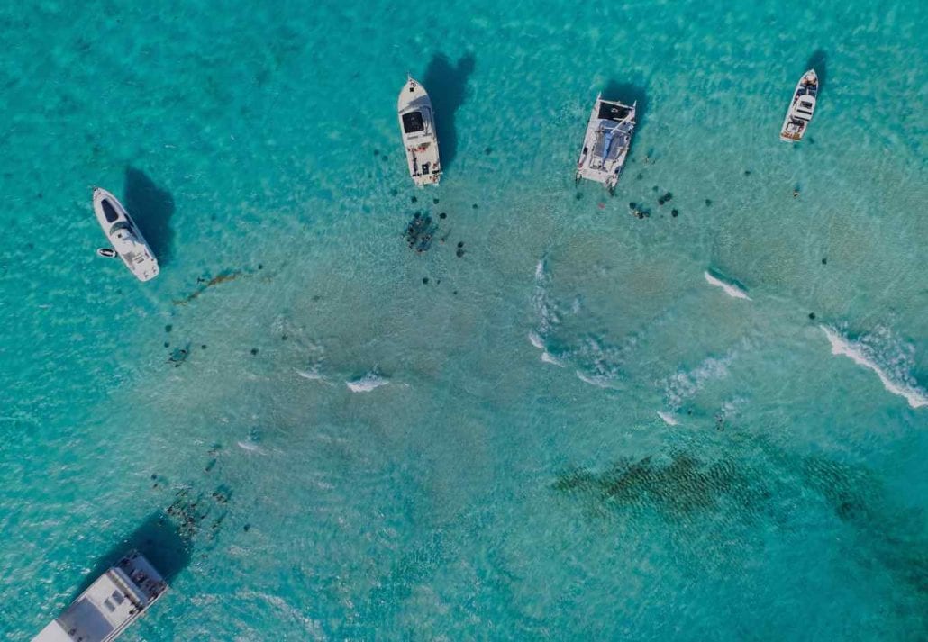 Boats on the transparent blue ocean in the Cayman Islands.