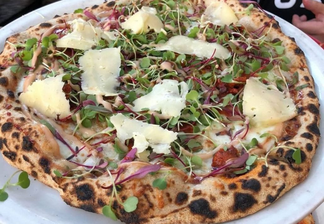 A golden crust pizza topped with parmesan cheese and herbs at Tony’s Pizza Napoletana, San Francisco, California.