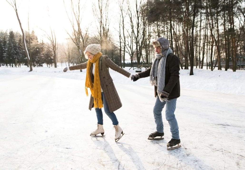 Senior couple ice skating.