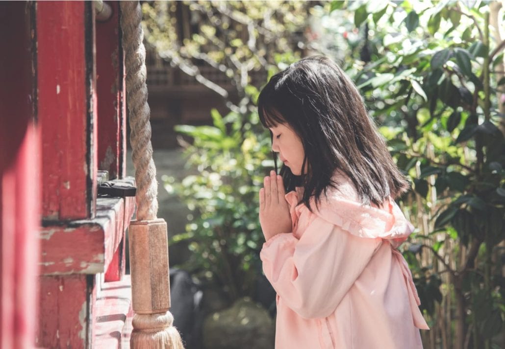 Asian girl is praying at the shrine,vintage filter