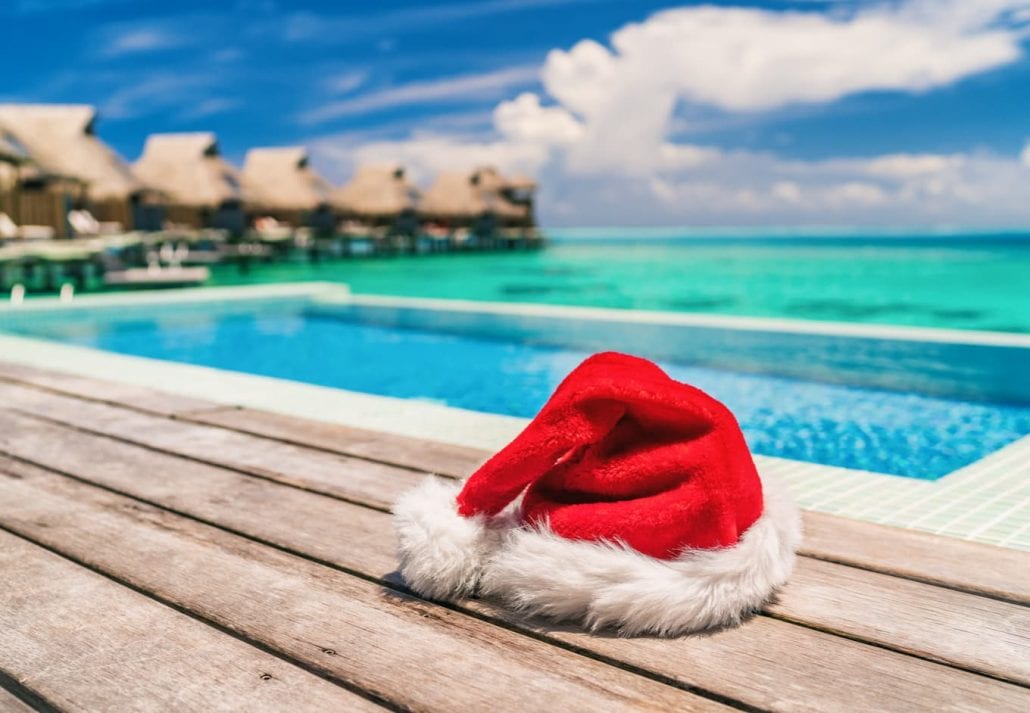 A santa claus hoodie by a swimming pool during a sunny sumer day.