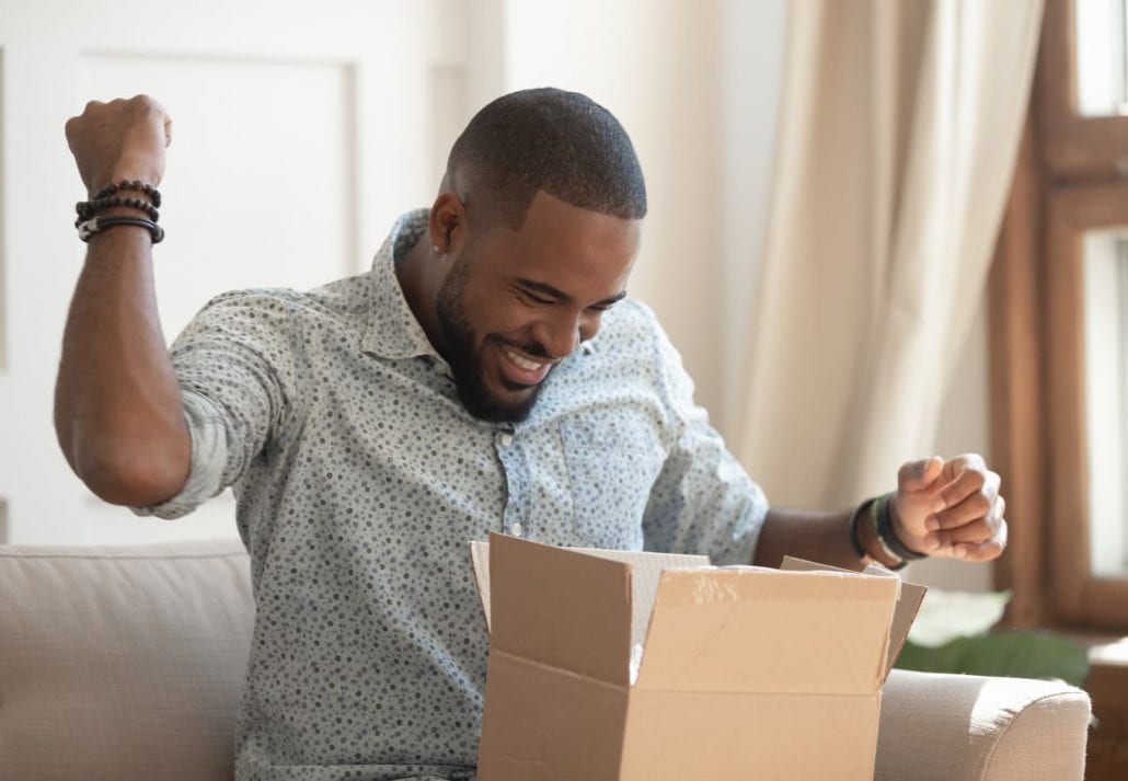 Excited men opening a package.