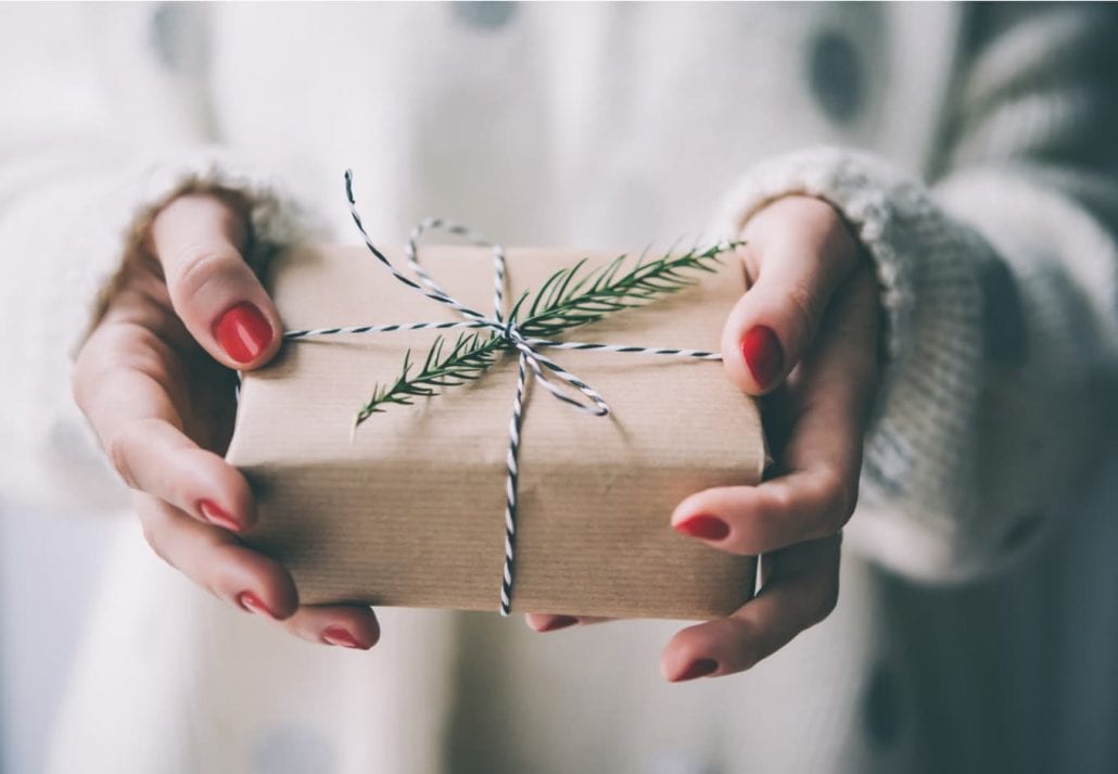 Woman holding handcrafted gift.