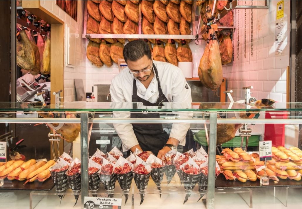 A man at a Food Stand Selling Iberico Ham in San Miguel Market