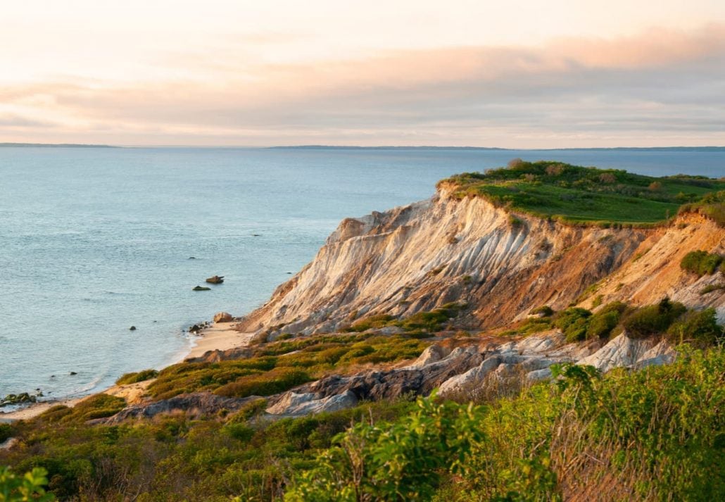 Sun sets illuminating sandy cliffs of Moshup Beach in Aquinnah, on Martha’s Vineyard island, in Massachusetts. 