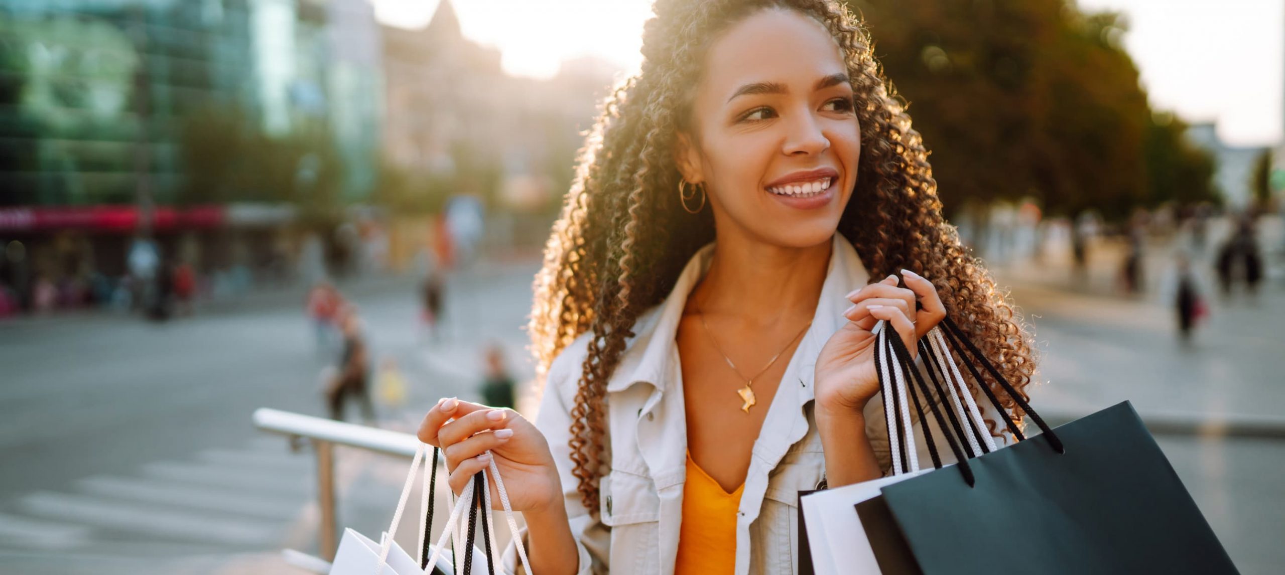 Fashion woman with shopping bags walking on street.