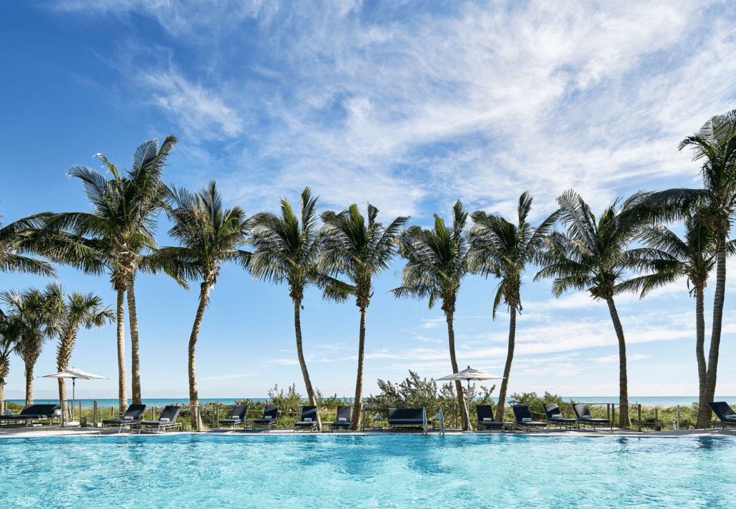 The palm-fringed pool of the Carillon Miami Wellness Resort, Miami Beach, Florida