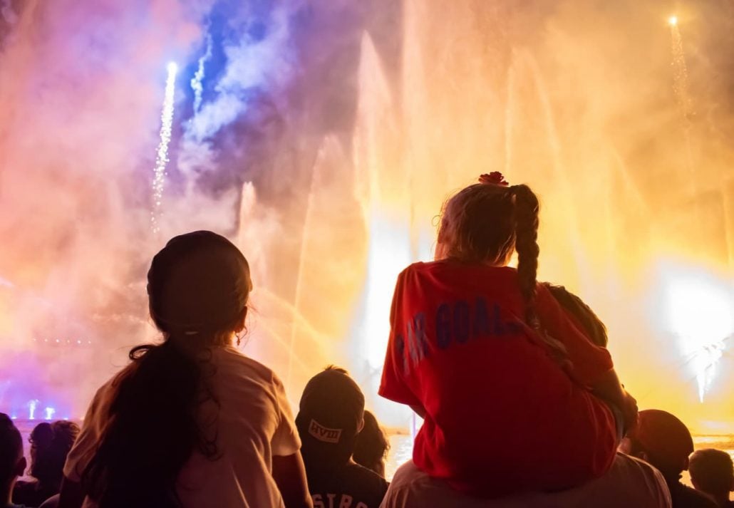 Little girls watching fireworks and water jets show at Seaworld