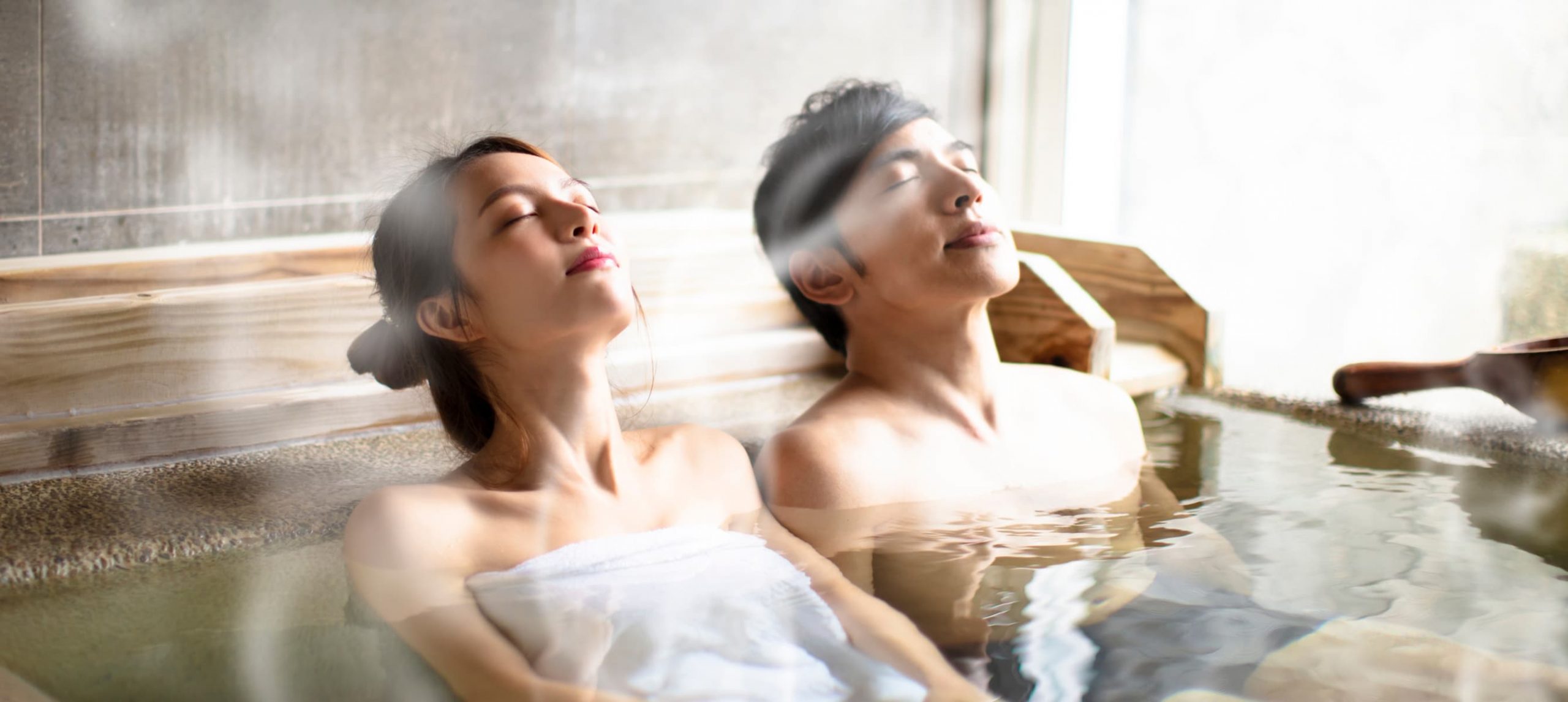 Young couple relaxing in hot springs