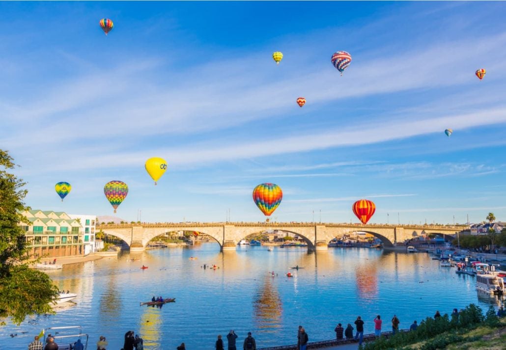 Hot air balloons flying over the London Bridge, in Lake Havasu, Arizona.