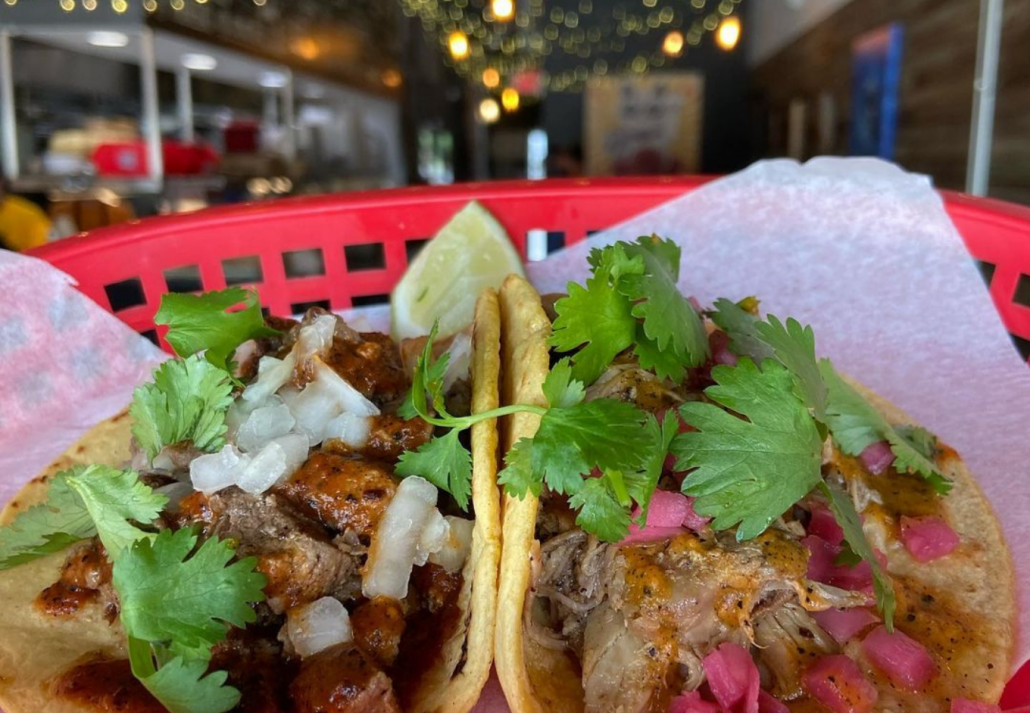 Two tacos topped with cilantro and served at the Black Rooster Taqueria, in Orlando.