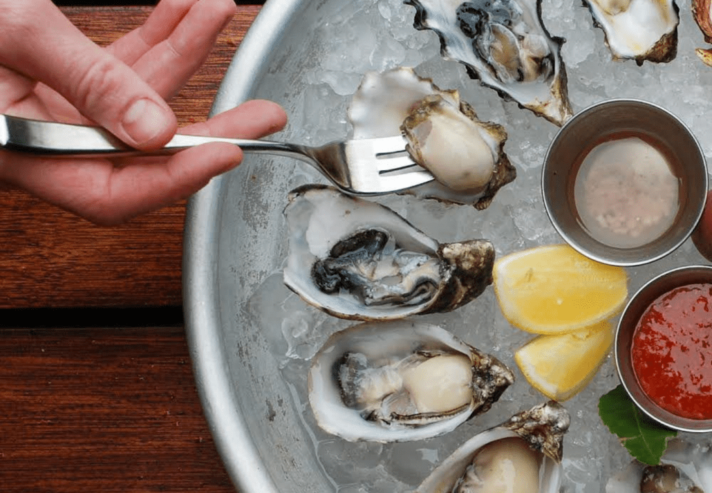 A plate of oysters over ice at Lukes Kitchen and Bar.