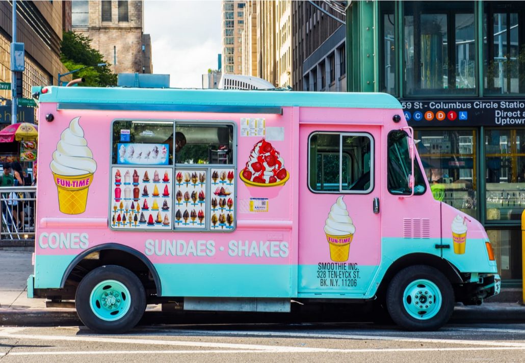 Pink and blue Ice Cream Truck on streets of Manhattan. Cones, Sundaes, Ice-cream and Shakes seller.