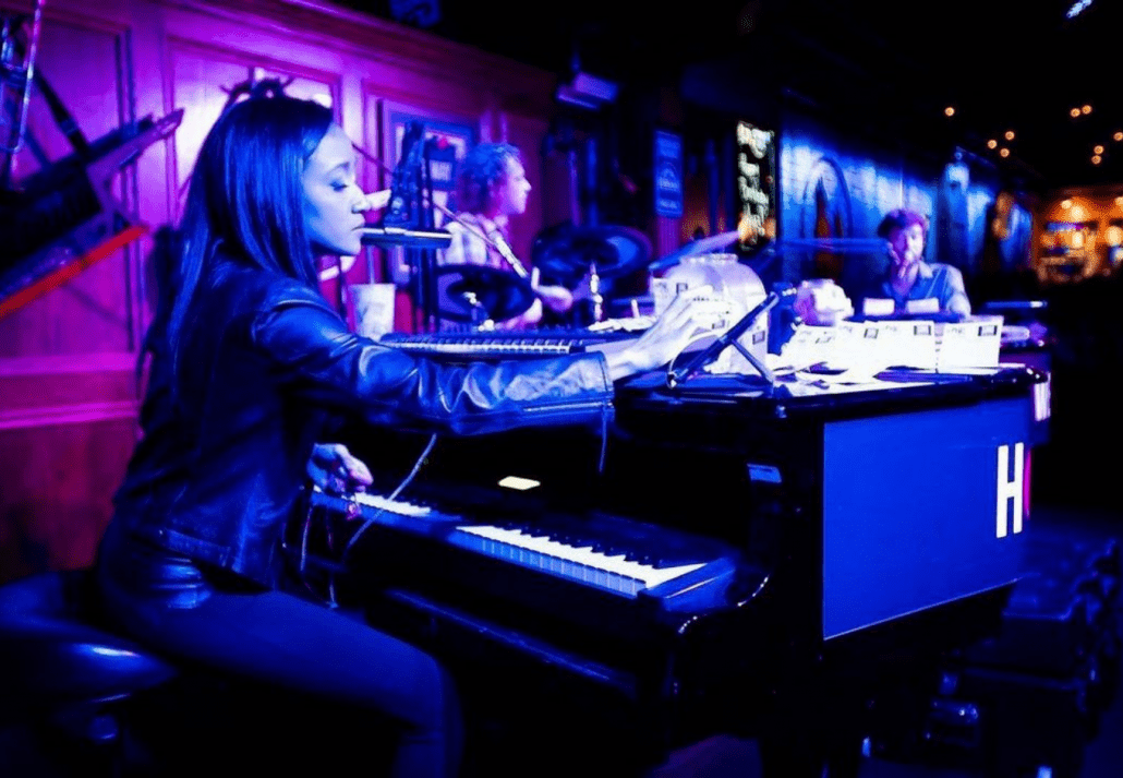 Young female musician performing at Howl at The Moon