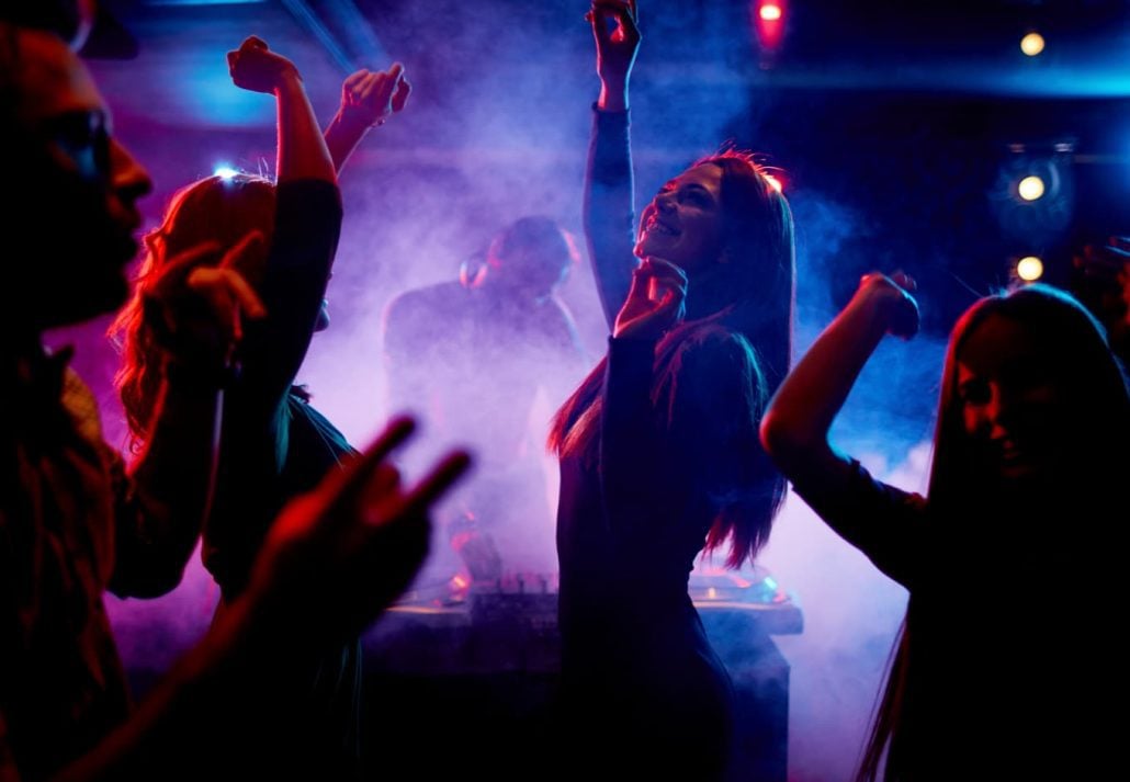 A group of young women dancing and having fun at a nightclub