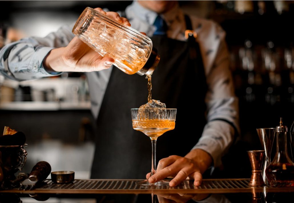 Mixologist making a hand-crafted coctail