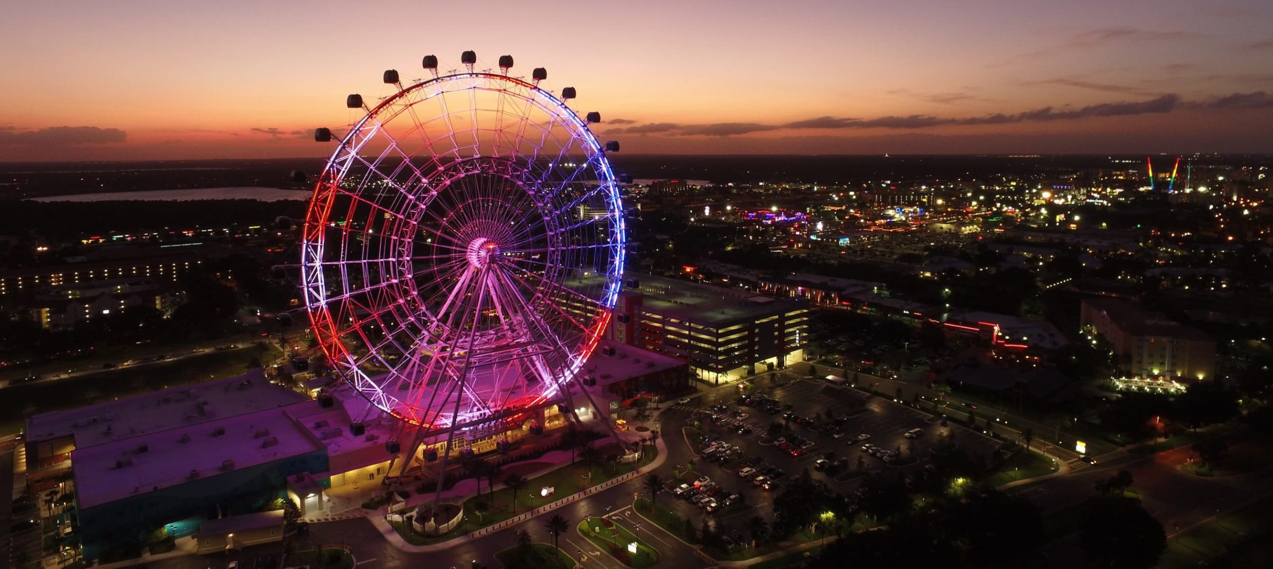 The Wheel at ICON Park iluminated at nighttime.