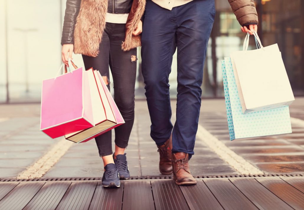 Couple holding shopping bags while shopping together.