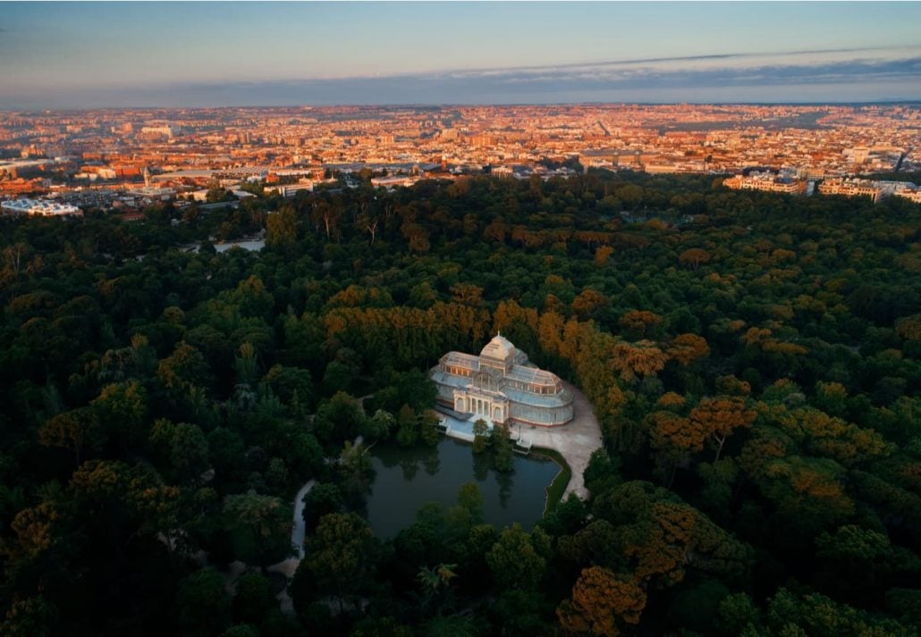 Aerial view of lonely Crystal Palace in El Retiro Park at sunrise in Madrid, Spain.