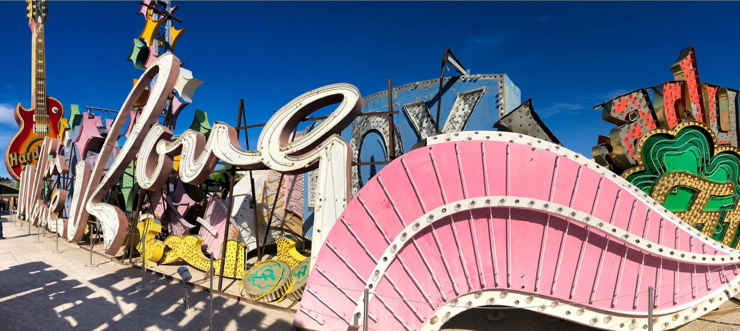 The Neon Museum, a collection of neon old signs on a beautiful sunny day. Panoramic view.