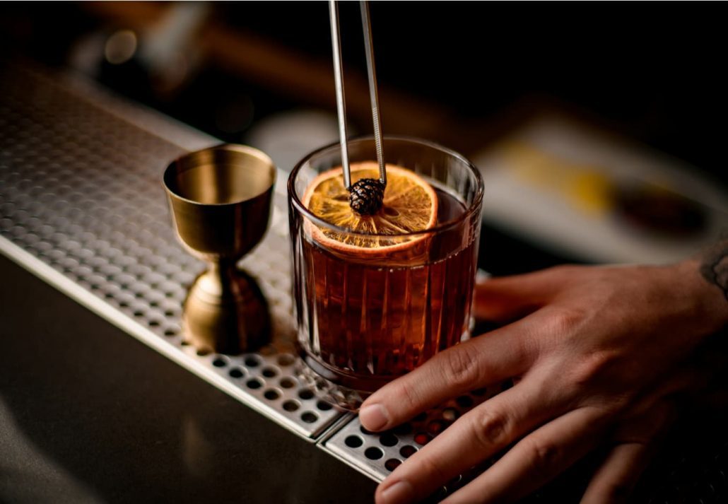 Bartender making elaborate cocktail.