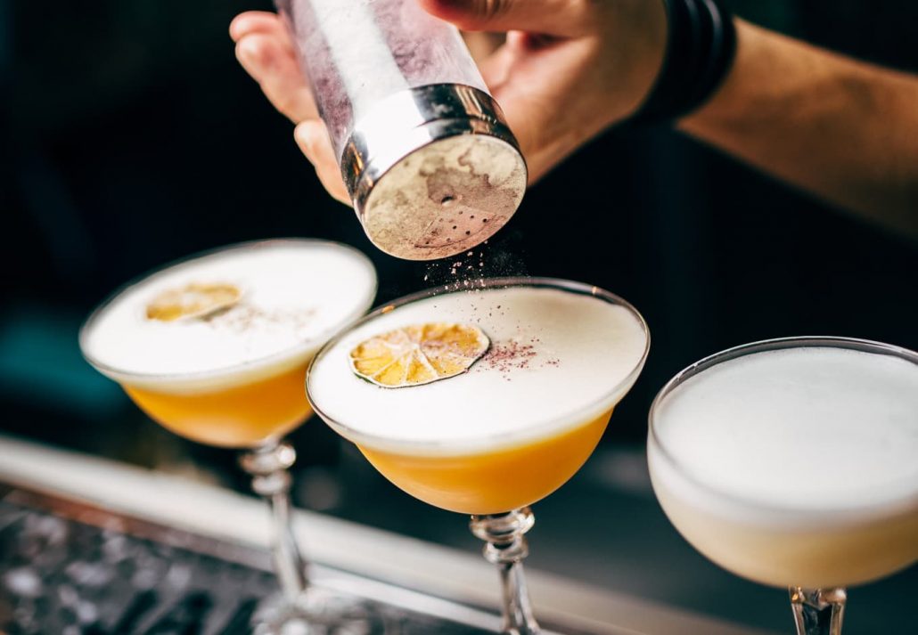 Bartender making an elaborate cocktail.