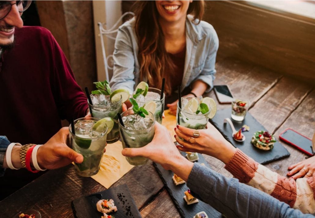 Group of friends toasting at a bar.