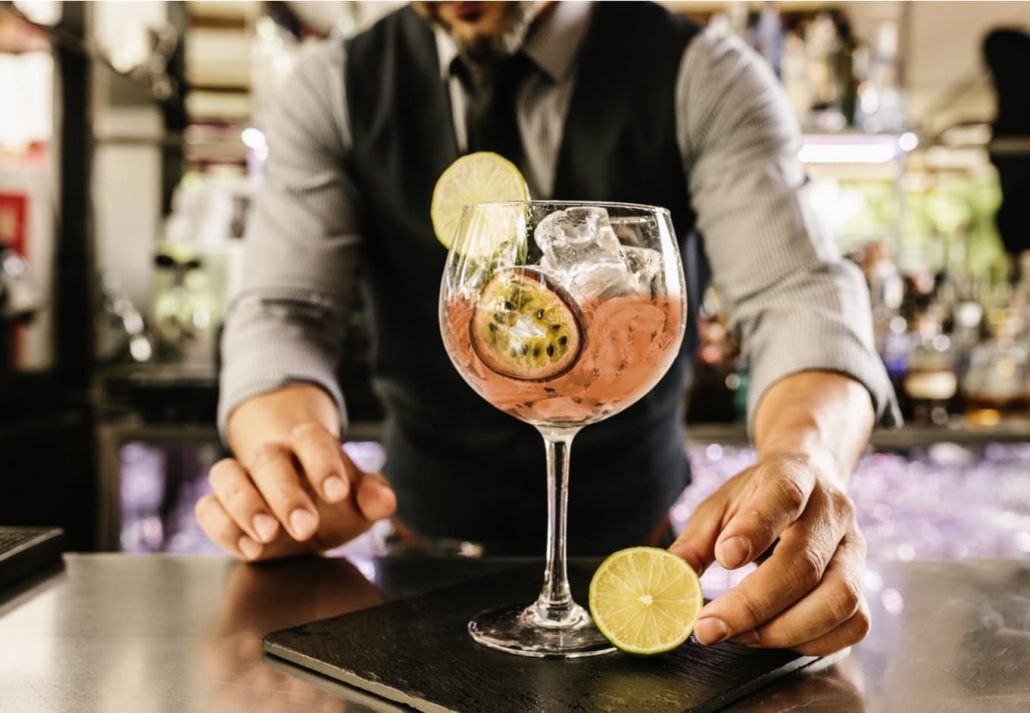 Bartender making an elaborate cocktail.