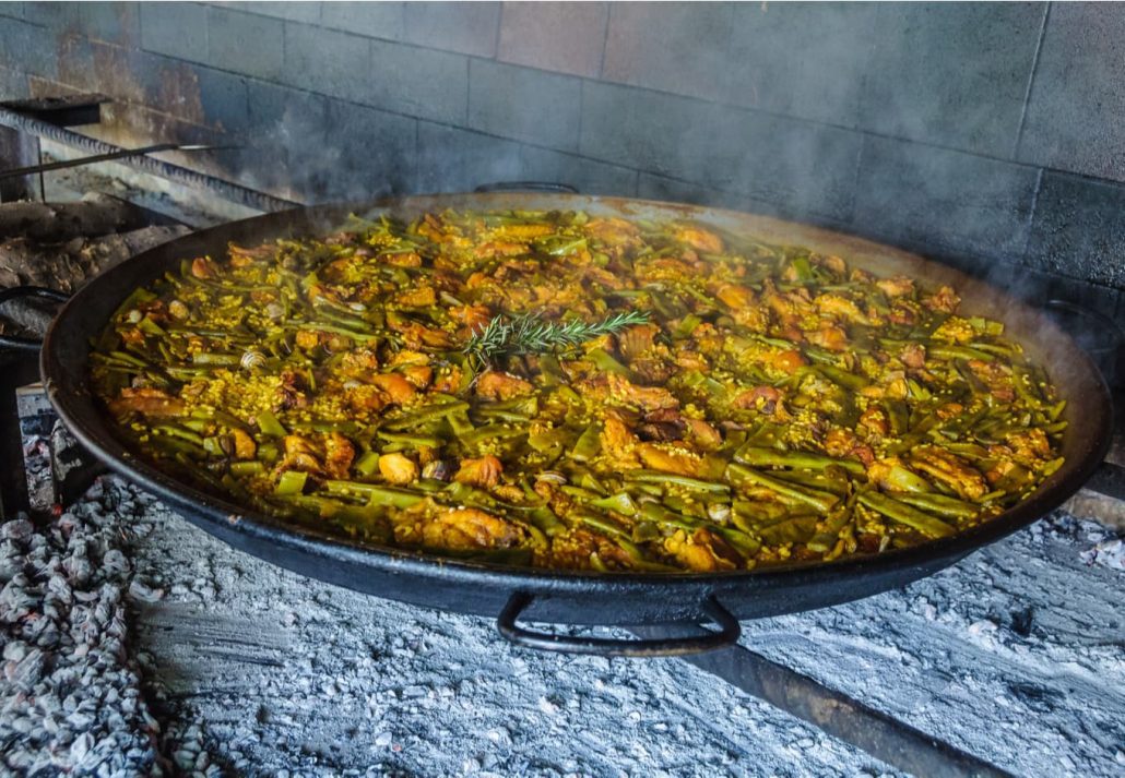 Cooking Paella with the fire of orange wood