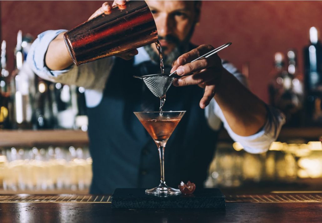Barman making a fresh and sweet summer cocktail