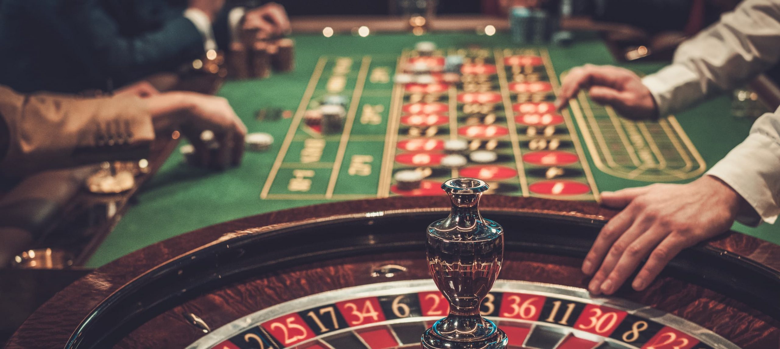 People playing table games in a casino.