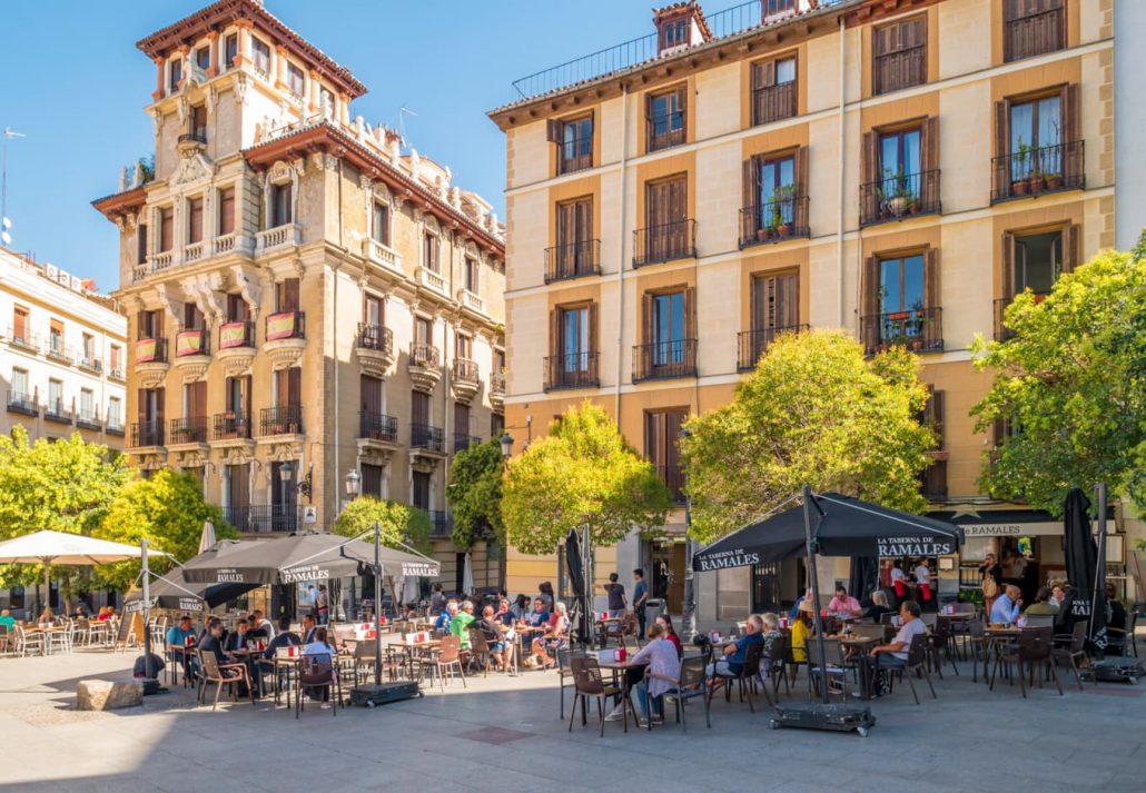 People sitting outside at tapas bars in sunny Madrid, Spain