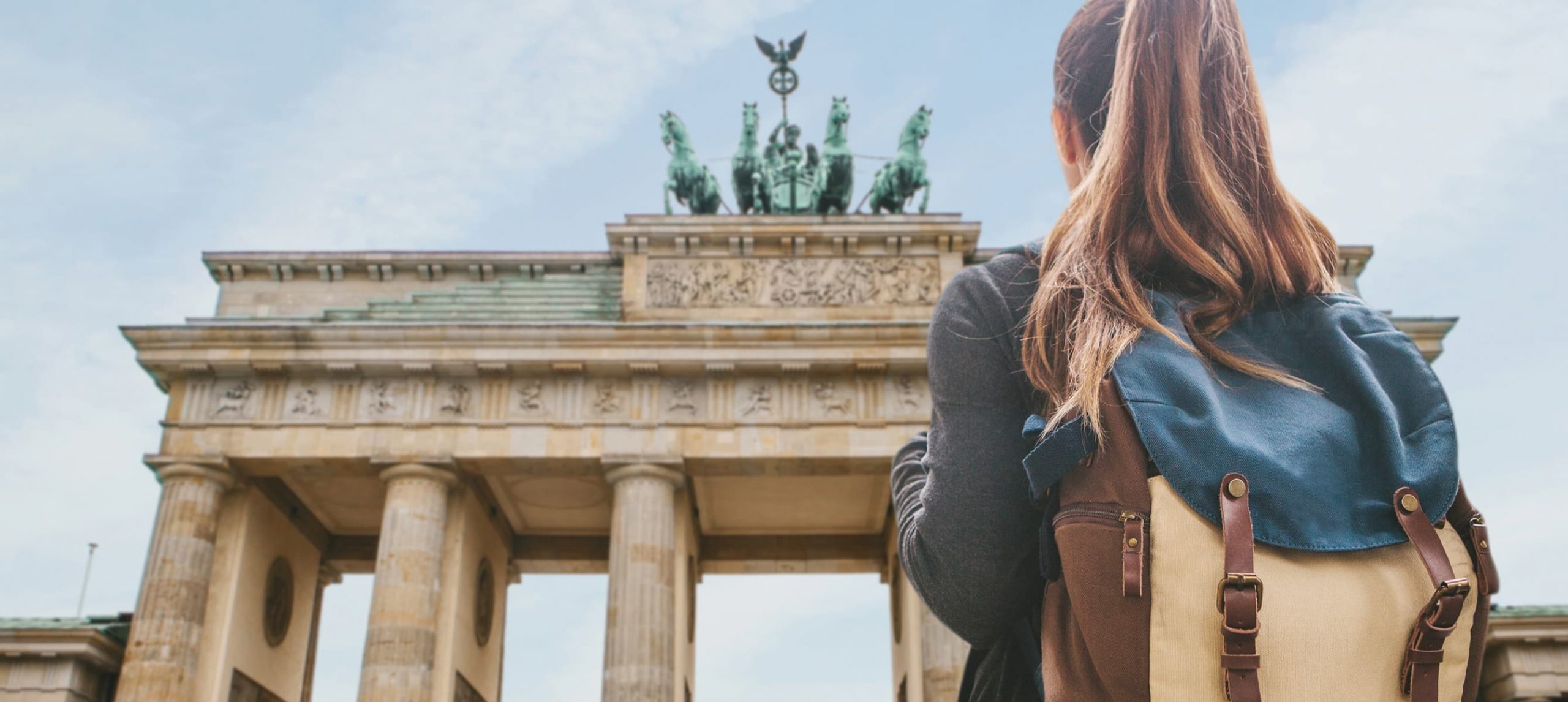 Young woman in front of the Bradenburg Gate, in Berlin, Germany.