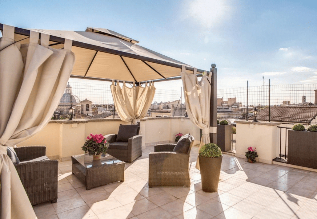 Rooftop terrace at Hotel Anfiteatro Flavio, Rome, Italy with blue sky