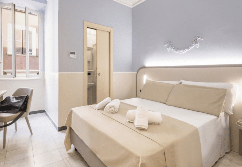 Airy bedroom in Hotel Grifo, Rome, Italy