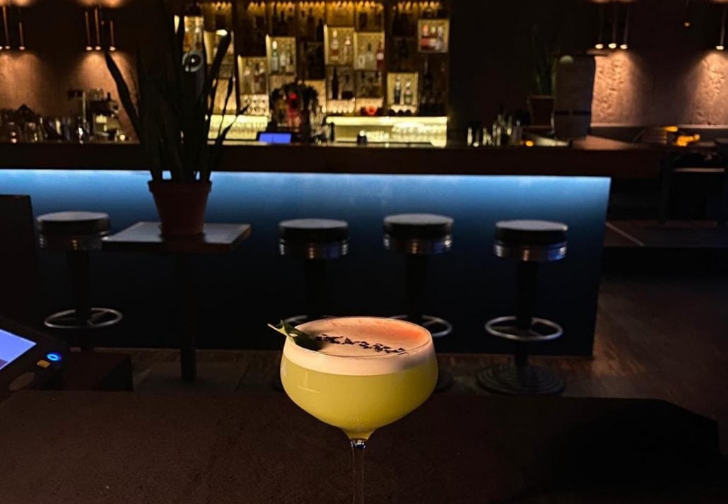 A cocktail served at Fahimi bar in Berlin with a view of the bartender rea