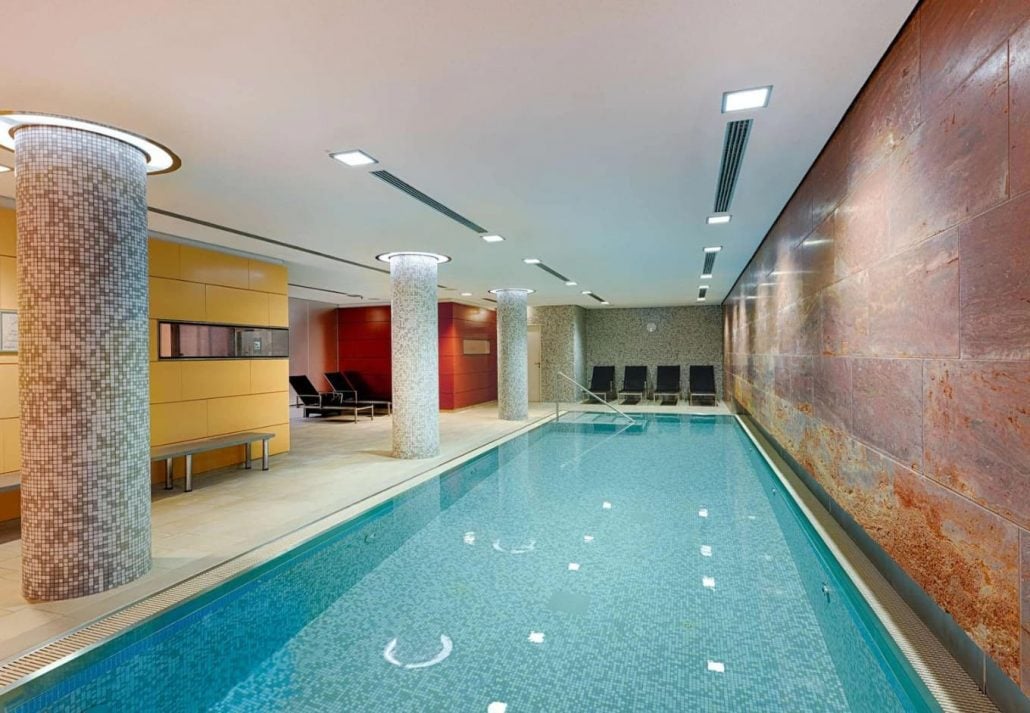 A pool next to a marbled wall at Heaven spa, Radisson Blue BerlinR