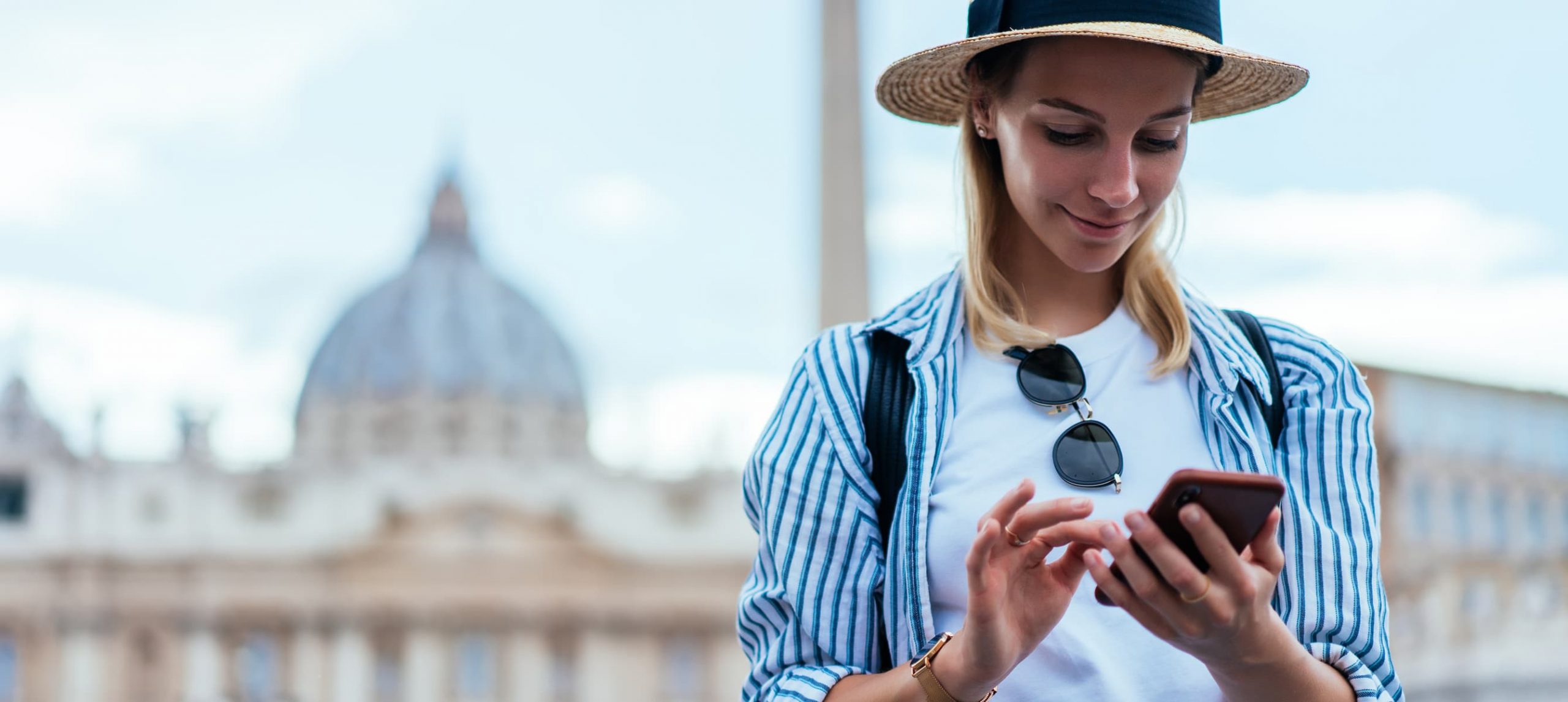 Young woman using her mobile phone in Rome.