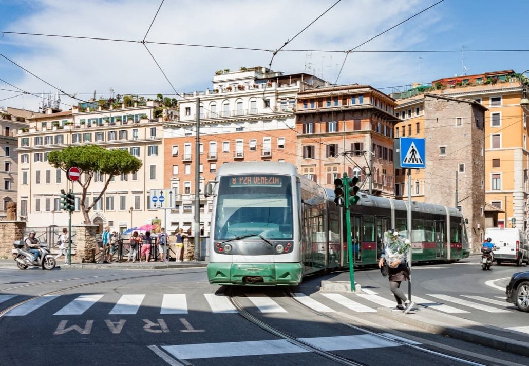 Green Rome Transit Car Navigating Through City Streets