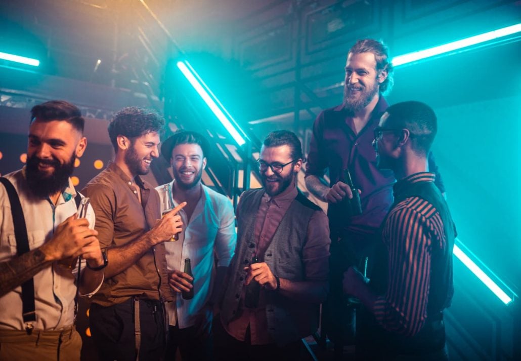 berlin-gay-party-scene-connection-club | CuddlyNest Travel Blog A group of men chatting and laughing at a nightclub