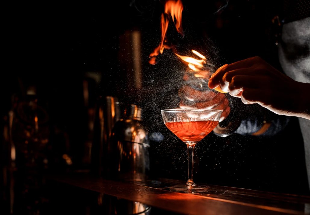 berlin-gay-party-scene-toms-bar | CuddlyNest Travel Blog A mixologist creating a drink in a dark bar