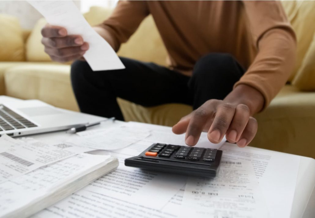 A man calculating costs with a calculator