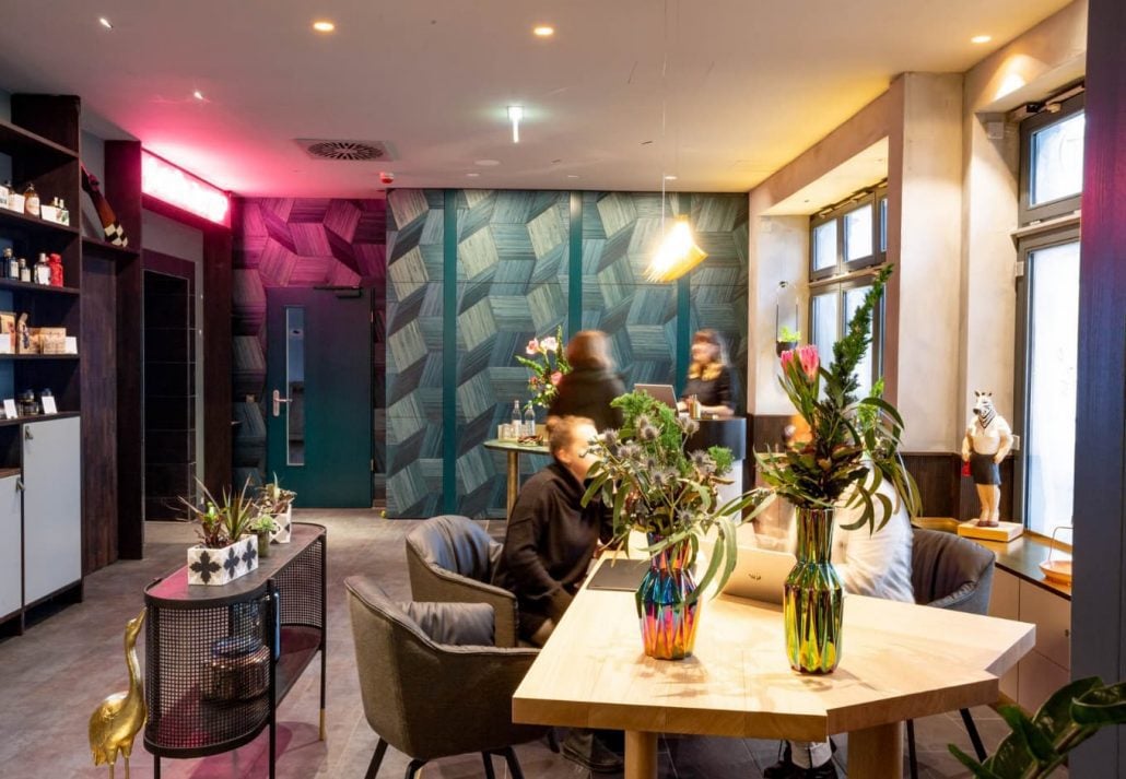 A lounge area with people chatting around the table in The Circus Hotel, Berlin