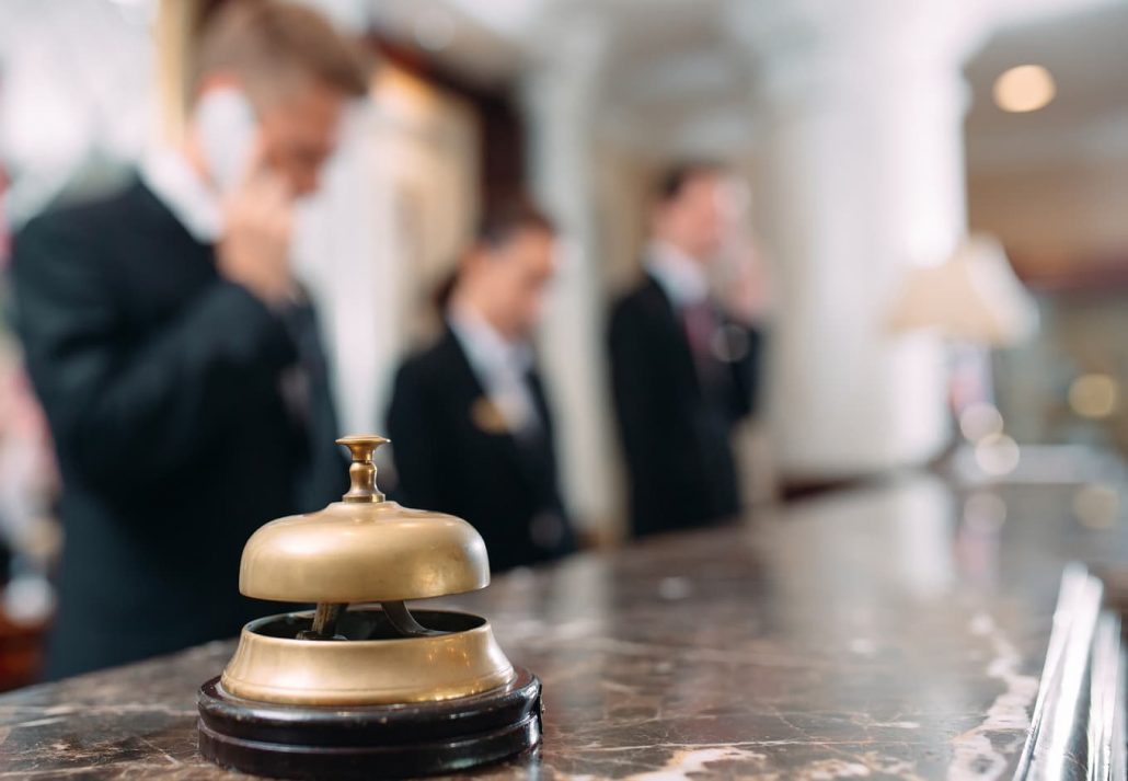 Receptionists working at their hotel desk