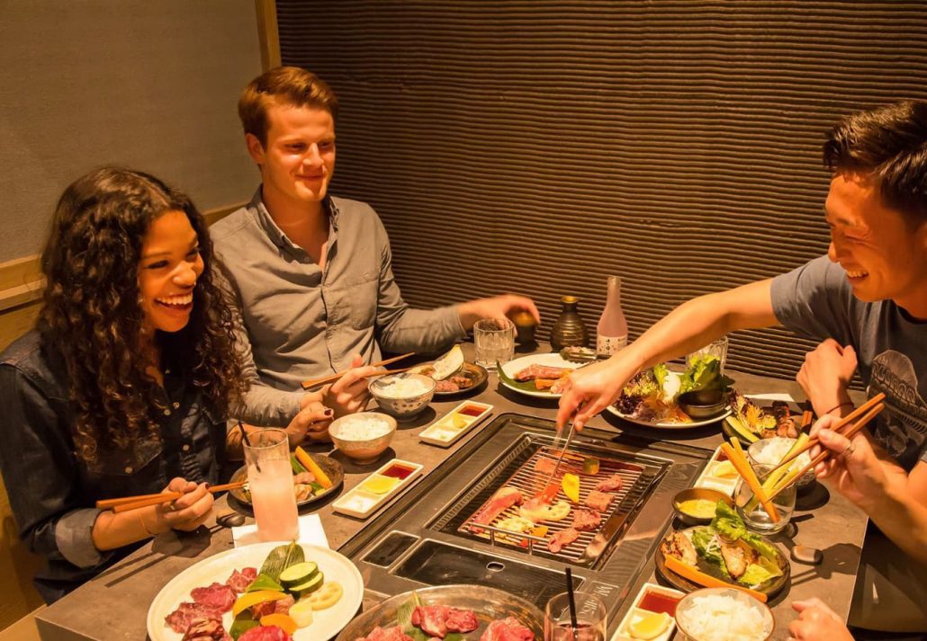 A group of people eating at the dining table at Ushido restaurant in Berlin