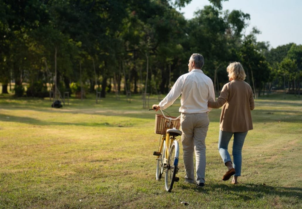 an older couple walking in the park