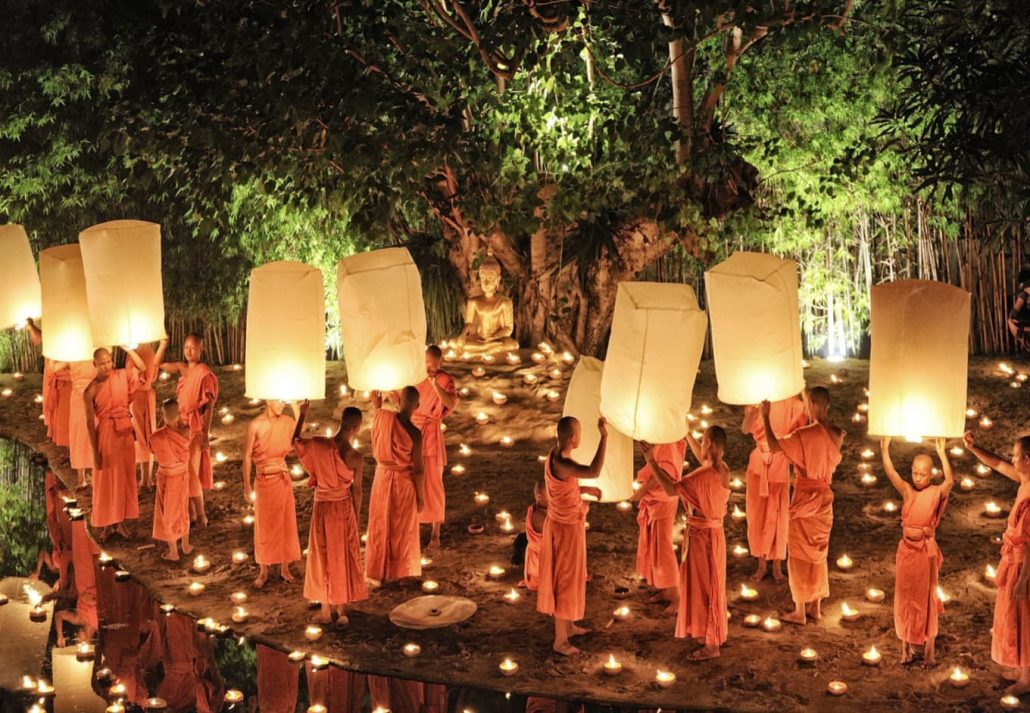 Monks holding light floating balloons at Same Loy Krathong festival in Chiang Mai